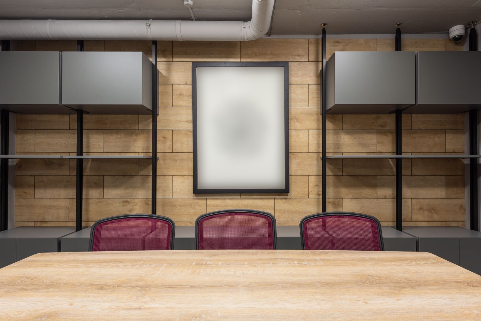 A contemporary boardroom with warm wood paneling and modern furniture
